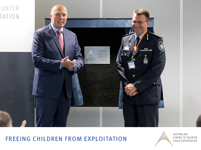 Former minister for home affairs standing with the Australian federal police commissioner