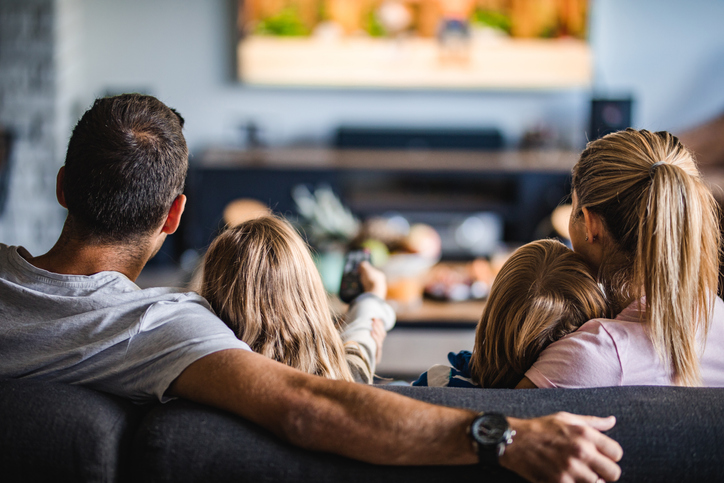 Family on couch looking at screen